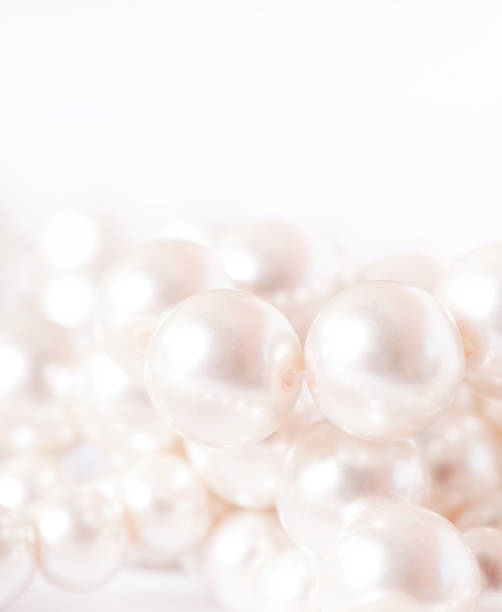 istock Pile of pearls on the white background 872393618