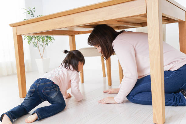 istock A parent and child huddling under a table 872393710