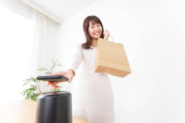 istock Young woman shipping with electronic money 872393716