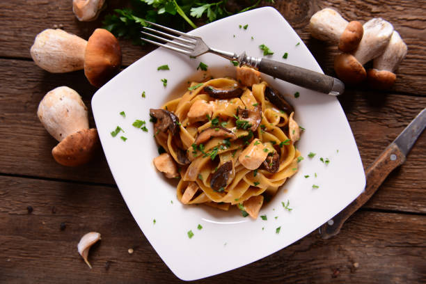PAsta with wild mushrooms Tagiatelle pasta with creamy sauce with porcini mushrooms and chicken porcini mushroom stock pictures, royalty-free photos & images