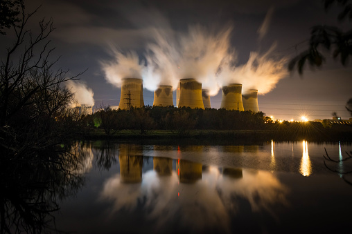 Drax power station at night reflected in a nearby lake