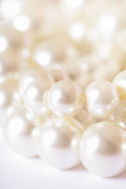 istock Pile of pearls on the white background 872398592