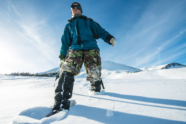 istock climber with an ice ax walks in the snowy mountains 872398862