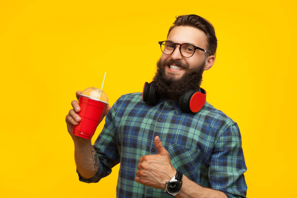 istock Excited man with healthy drink in studio 872409666