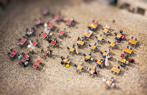 People sitting at outdoors cafe on the city square People sitting at outdoors cafe on the city square. Top view. Tilt-shift Miniature Effect tilt shift stock pictures, royalty-free photos & images