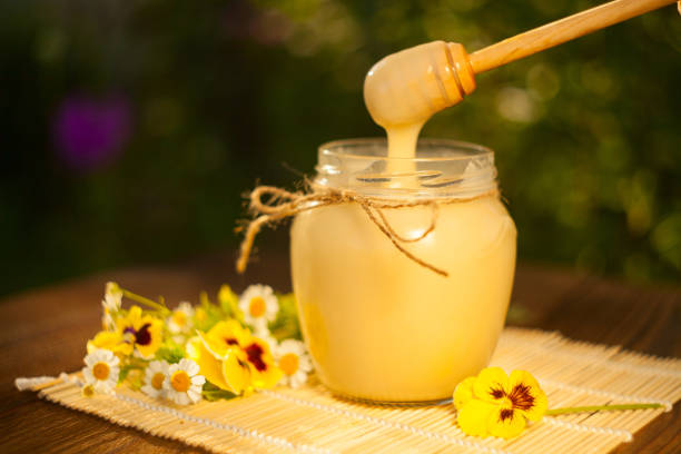 istock Delicious delicious honey in  jar on table 872414568