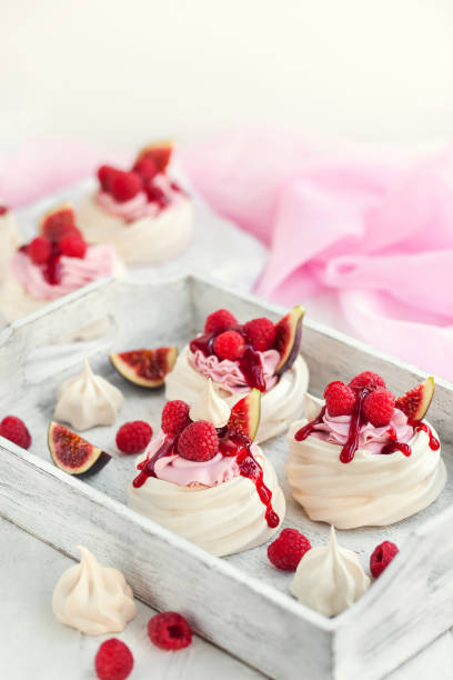 Delicious mini Pavlova meringue cake decorated with fresh raspberry