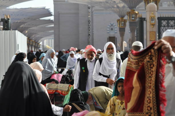 Crowded people at street of Medina Province, Saudi Arabia. Feb 14, 2012 Crowded people at street of Medina Province, Saudi Arabia. Feb 14, 2012 al masjid an nabawi stock pictures, royalty-free photos & images