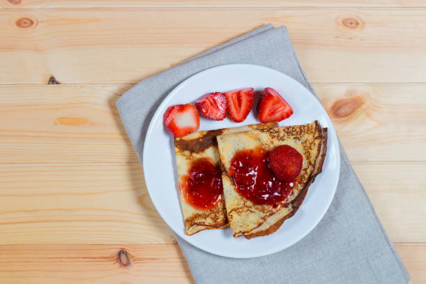 istock Crepes with fresh strawberries and jam 872424830