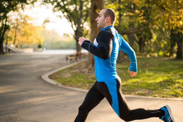 istock Man running fast in the park on sunrise 872424992
