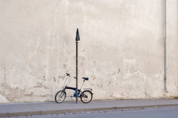 istock Bicycle locked to the sign pole near the concrete wall 872425004