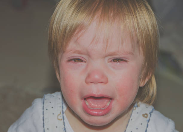 istock Close up, baby crying and looking at the camera 872432918