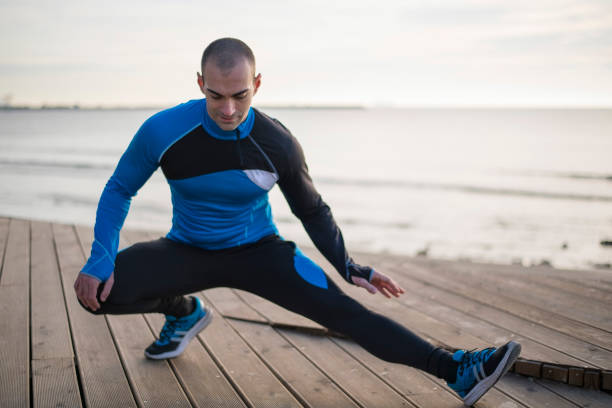 istock Man stretching near the sea 872435964