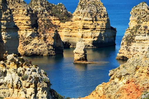 Lagos, Algarve, Portugal: scenic rock formations at Ponta da Piedade - rock pinnacle, cliffs and islet - picturesque colored cliffscape