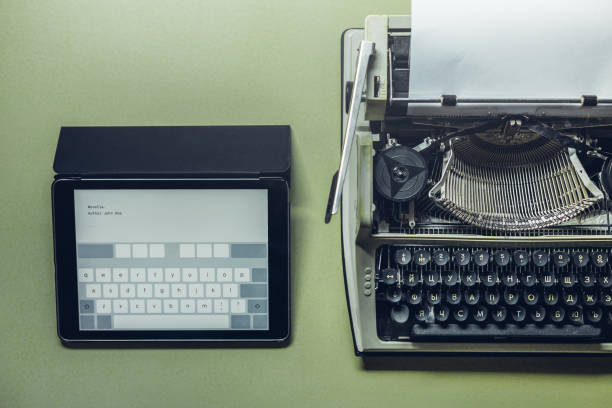 istock Analog and digital typewriters lie on the green surface. Continuity of generations, technology development concept 872441338