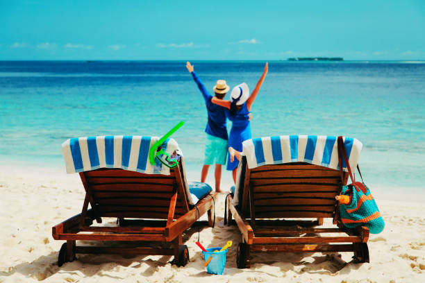 istock happy couple relax on a tropical beach 872442114