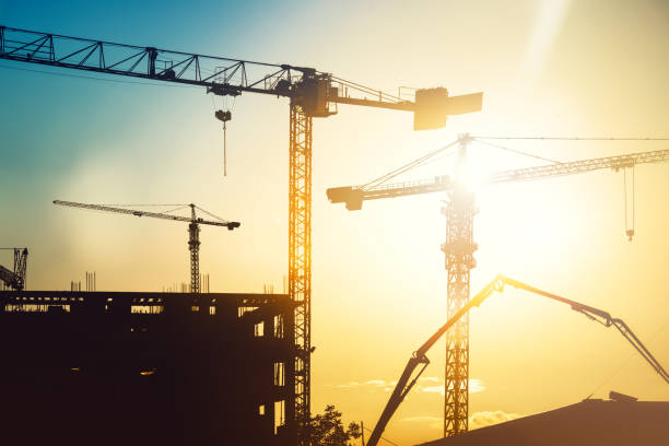 istock construction site with tower cranes and building silhouettes 872445158