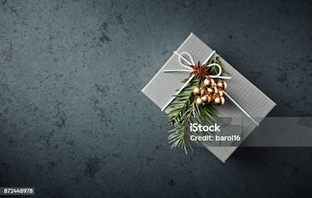 Christmas Present Decorated With Yew Twigs And Anise Stock Photo - Download Image Now