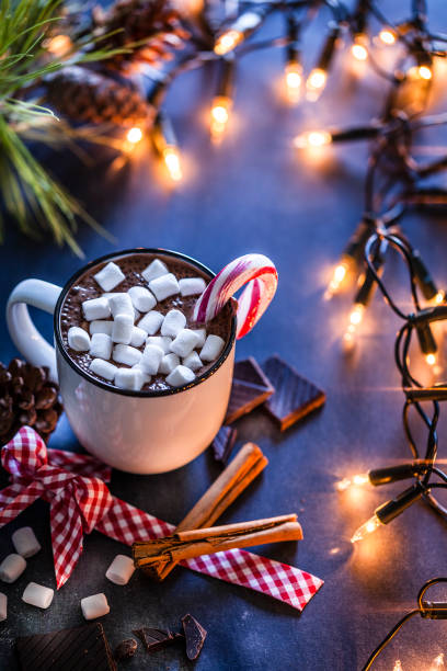 istock Homemade hot chocolate mug with marshmallows on rustic wooden Christmas table 872454132