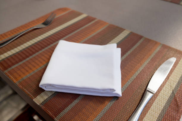 istock Napkin and cutlery on tablecloths. Dinner place setting 872454218