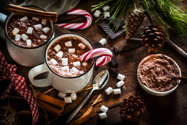 istock Two homemade hot chocolate mugs with marshmallows on rustic wooden Christmas table 872456936