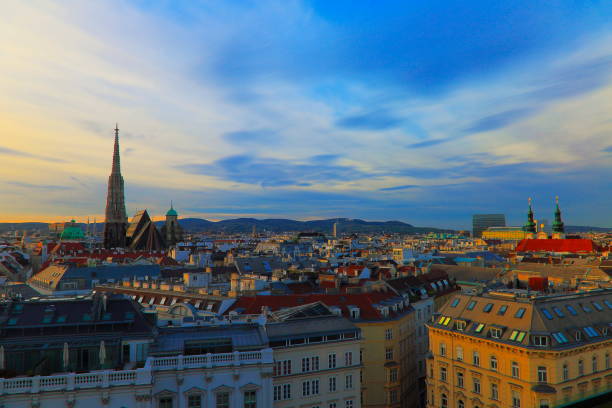 istock Above Beautiful Vienna Cityscape panorama, with St. Stephen's Cathedral, impressive building architecture and urban skyline at dramatic sunset – Vienna , Austria 872457800