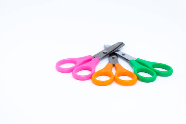istock Colorful scissors (pink, orange and green) , a tool used for cutting paper isolated on white background. 872460752