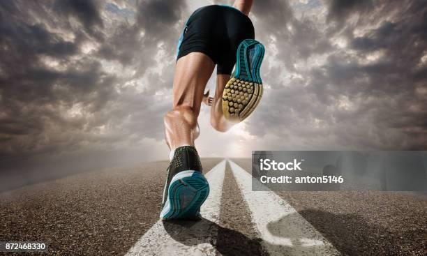 The Close Up Feet Of Man Running And Training On Running Track Stock Photo - Download Image Now
