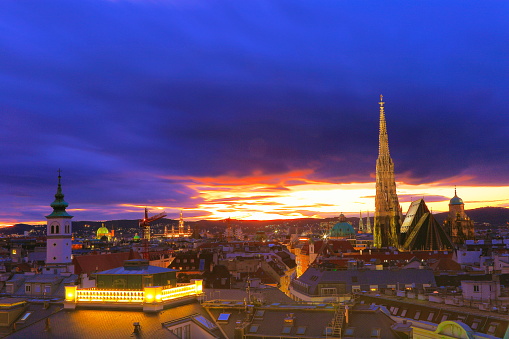 Above Beautiful Vienna Cityscape panorama, with St. Stephen's Cathedral, impressive building architecture and urban skyline at dramatic evening – Vienna , Austria