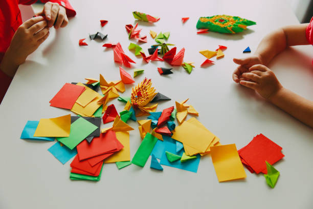istock kids making origami crafts with paper 872475754