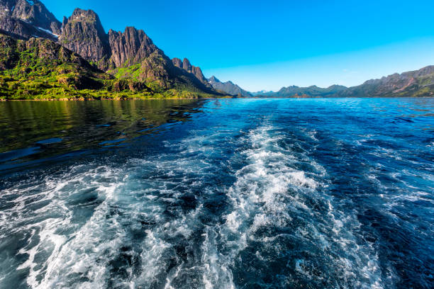 Trail  behind of the ship on water surface on Trollfjord (Trollfjorden) in the Lofoten Islands, Norway.