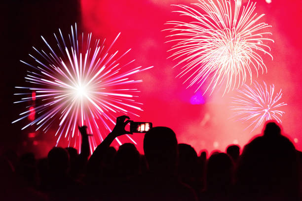 istock Silhouette of hands recording New Year fireworks 872476760