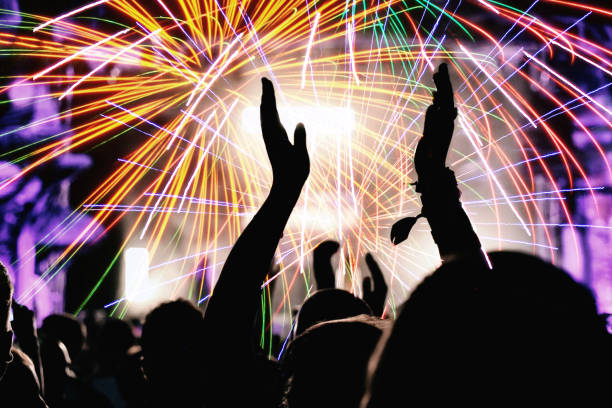istock Cheering crowd and fireworks. New Year's Eve party 872476788