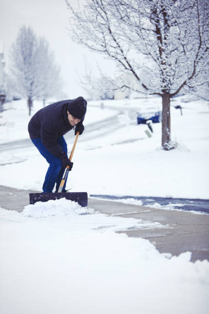 istock Man Struggling To Shovel Wet Snow 872483948