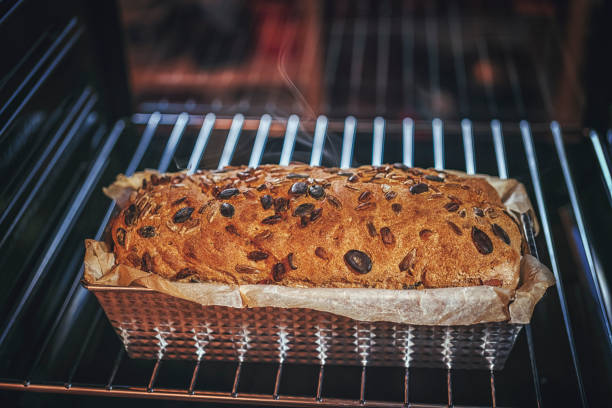 istock Baking Homemade Seed Bread in the Oven 872484270