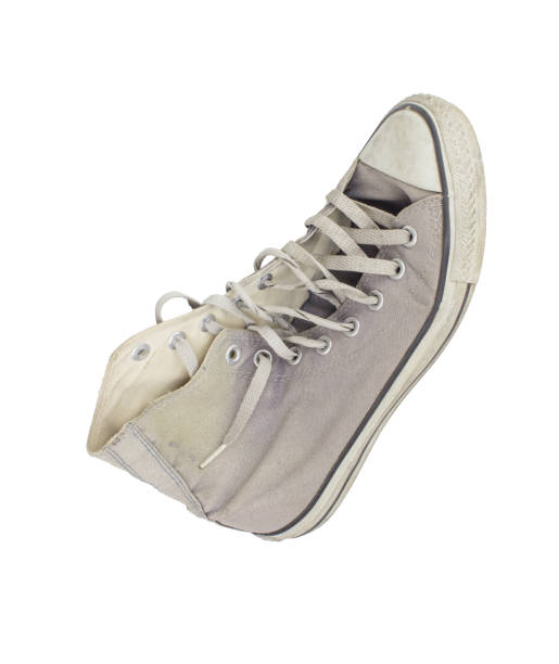istock Old sneakers shoes isolated from white background, fall color shoes 872486736