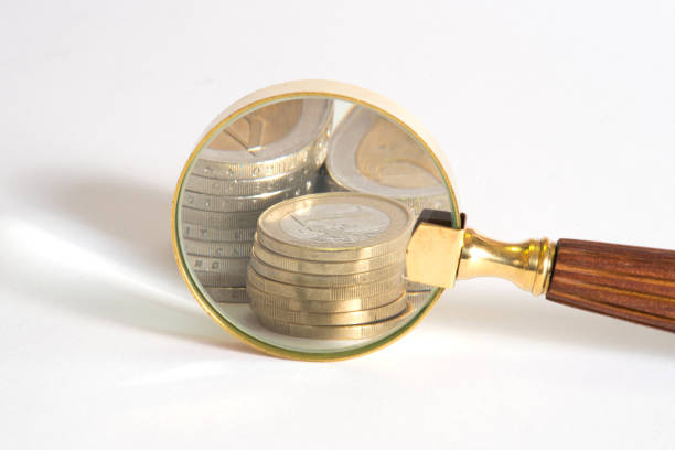 istock Euro coins and magnifying glass 872491740