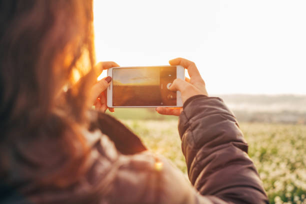 istock Teenager taking landscape photos 872492272