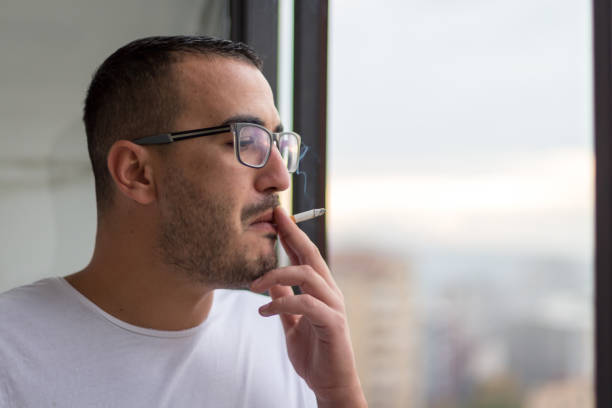 istock Young man relaxing and smoking 872495022