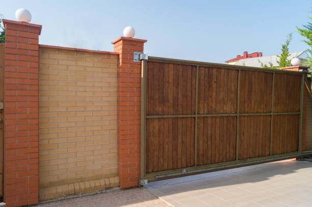 istock Brown automatic wooden gates of private house. Inside view 872497104