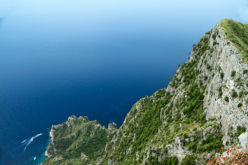 Looking at a cliff on the island of Capri with the ocean fading into the sky.