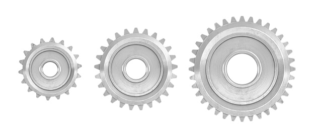 3d rendering of three straight gears of different sizes in front view isolated on a white background. Machinery parts. Gearbox. Spur and straight gears.