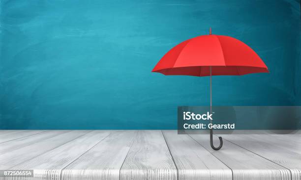 3d Rendering Of A Single Red Classic Umbrella With An Open Canopy Standing Above A Wooden Desk On Blue Background Stock Photo - Download Image Now