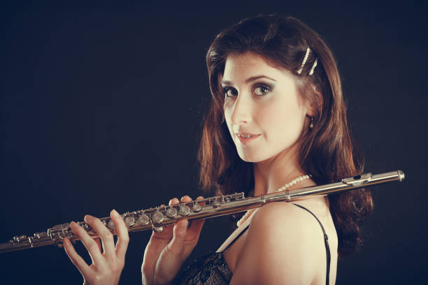 istock Elegant woman with flute instrument. 872530734