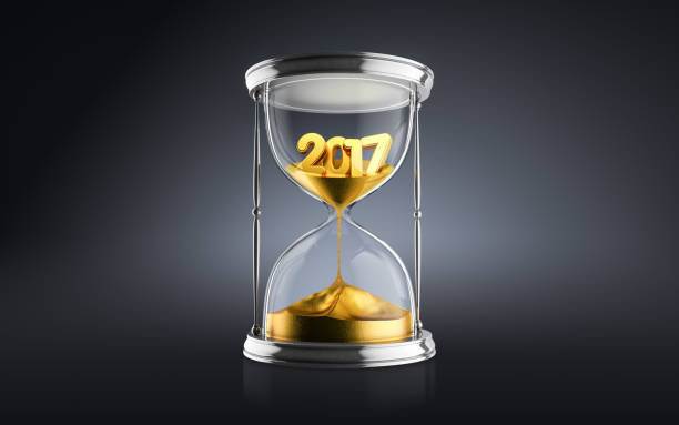 istock New Year 2018 concept with hourglass falling sand taking the shape of a 2018 872530846