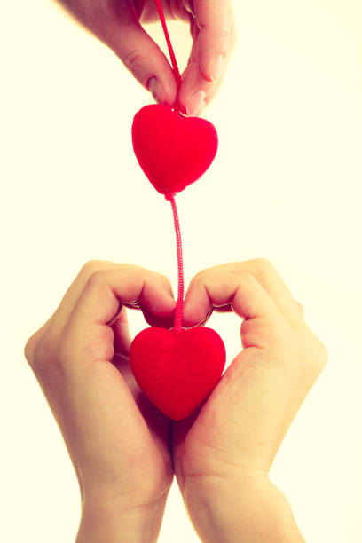 istock Female hands with little hearts. 872531254