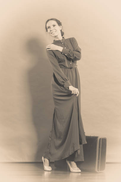 istock Woman retro style with old suitcase 872534560