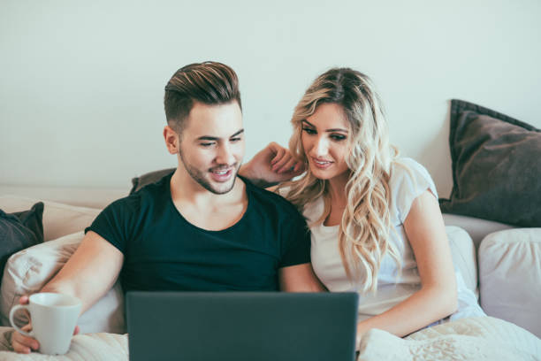 istock Couple on the sofa looking at something on the laptop 872535030