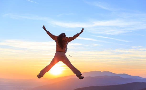 istock Cheerful woman on top mountain 872542562