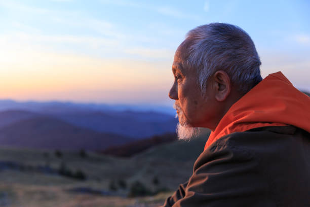 istock Senior asian man resting on top mountain 872542564